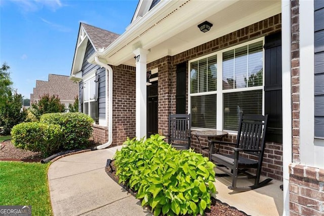 17 Twelve Oaks Dr, Cartersville, GA 30120 - doorway to property with covered porch, brick siding, and a shingled roof