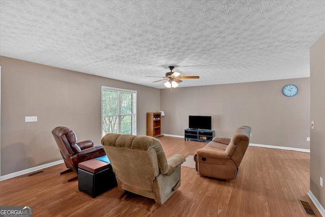 11 Chestnut St, Cartersville, GA 30120 - living room with wood finished floors, ceiling fan, baseboards, and a textured ceiling