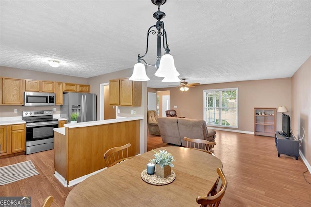 11 Chestnut St, Cartersville, GA 30120 - dining room with a textured ceiling, light wood-type flooring, ceiling fan, and baseboards