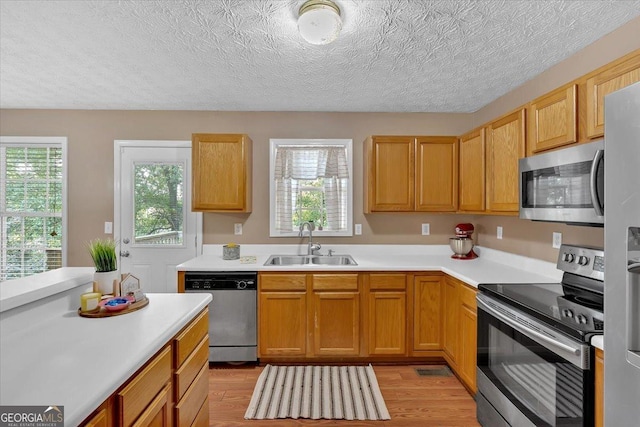 11 Chestnut St, Cartersville, GA 30120 - kitchen featuring appliances with stainless steel finishes, a sink, plenty of natural light, light countertops, and a textured ceiling