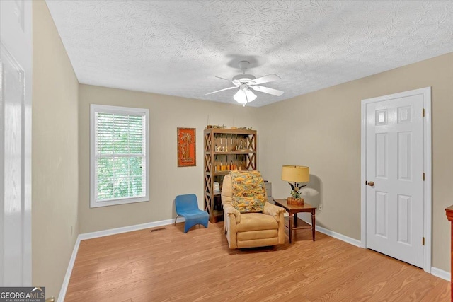 11 Chestnut St, Cartersville, GA 30120 - living area with wood finished floors, ceiling fan, baseboards, and a textured ceiling