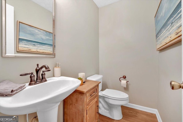 11 Chestnut St, Cartersville, GA 30120 - bathroom with wood finished floors, a sink, toilet, and baseboards