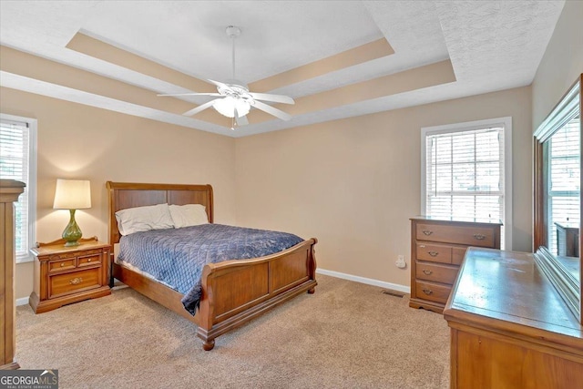 11 Chestnut St, Cartersville, GA 30120 - bedroom with a tray ceiling, baseboards, light colored carpet, and ceiling fan