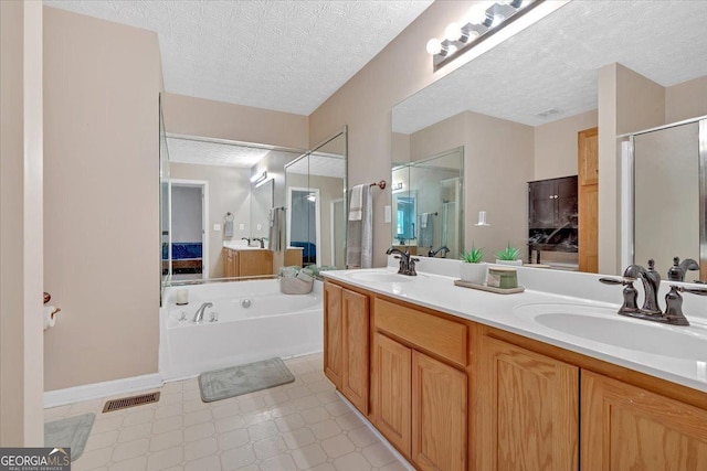 11 Chestnut St, Cartersville, GA 30120 - bathroom with a stall shower, a textured ceiling, double vanity, a bath, and tile patterned floors