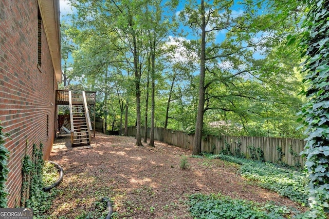 11 Chestnut St, Cartersville, GA 30120 - fenced backyard with stairs and a wooden deck