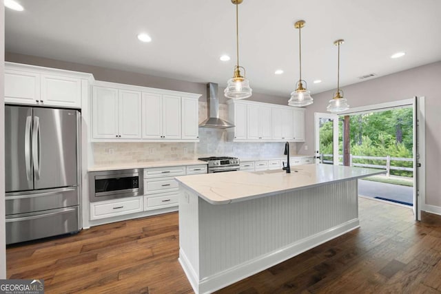 12 Bridgestone Way SE, Cartersville, GA 30120 - kitchen with stainless steel appliances, wall chimney range hood, tasteful backsplash, white cabinetry, and dark wood-style flooring