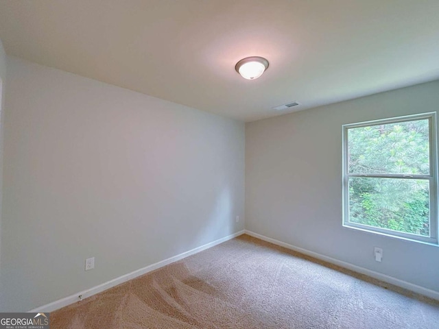 1531 Iris Walk, Jonesboro, GA 30238 - spare room featuring baseboards and carpet flooring