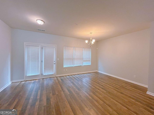 1531 Iris Walk, Jonesboro, GA 30238 - empty room with a chandelier, wood finished floors, and baseboards