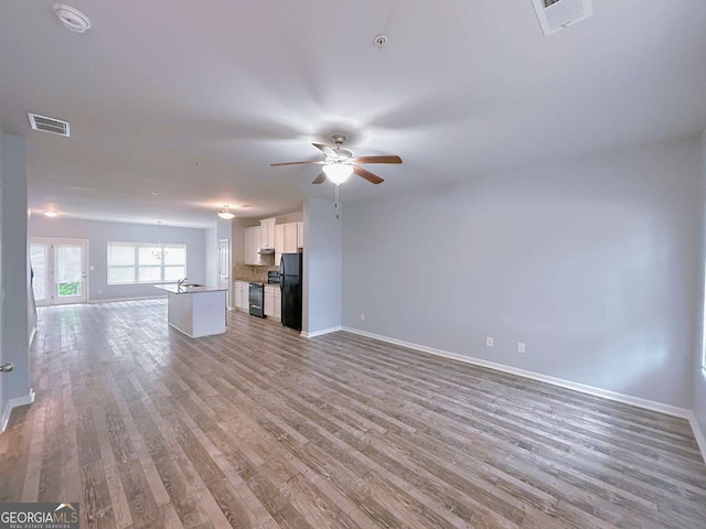 1892 Old Dogwood, Jonesboro, GA 30238 - unfurnished living room featuring baseboards, light wood-style flooring, and ceiling fan