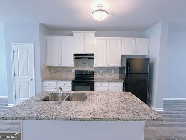 1892 Old Dogwood, Jonesboro, GA 30238 - kitchen with black appliances, under cabinet range hood, a sink, white cabinetry, and light wood finished floors