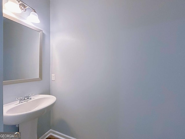 1892 Old Dogwood, Jonesboro, GA 30238 - bathroom featuring baseboards and a sink