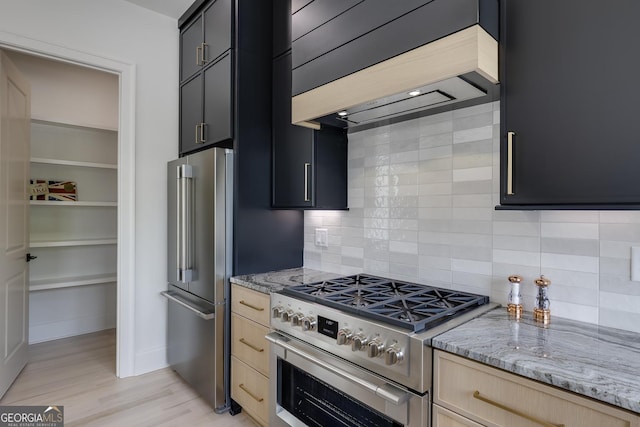 1962 8th St, Chamblee, GA 30341 - kitchen featuring high end appliances, light brown cabinets, custom exhaust hood, and decorative backsplash