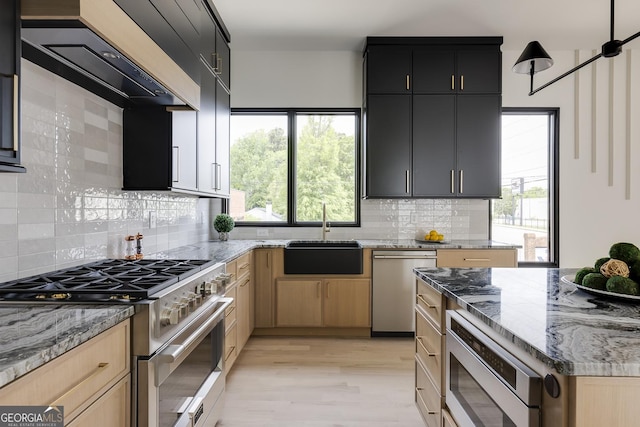 1962 8th St, Chamblee, GA 30341 - kitchen with stainless steel appliances, a sink, light stone countertops, decorative backsplash, and light wood-style floors