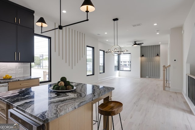 1962 8th St, Chamblee, GA 30341 - kitchen with healthy amount of natural light, recessed lighting, light wood finished floors, dark cabinets, and a chandelier