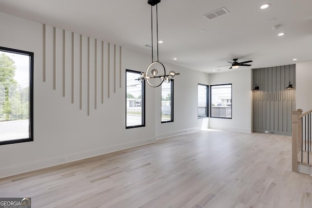 1962 8th St, Chamblee, GA 30341 - unfurnished living room with recessed lighting, light wood-style floors, a chandelier, baseboards, and a ceiling fan