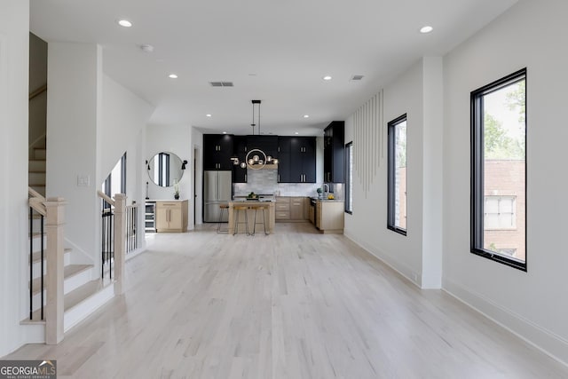 1962 8th St, Chamblee, GA 30341 - unfurnished living room featuring stairs, light wood-style floors, recessed lighting, baseboards, and a chandelier