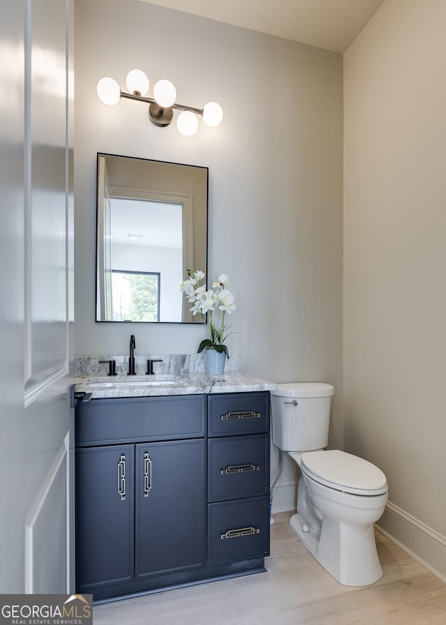 1962 8th St, Chamblee, GA 30341 - bathroom with vanity, baseboards, toilet, and wood finished floors