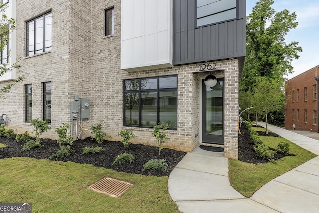 1962 8th St, Chamblee, GA 30341 - view of exterior entry featuring board and batten siding and brick siding