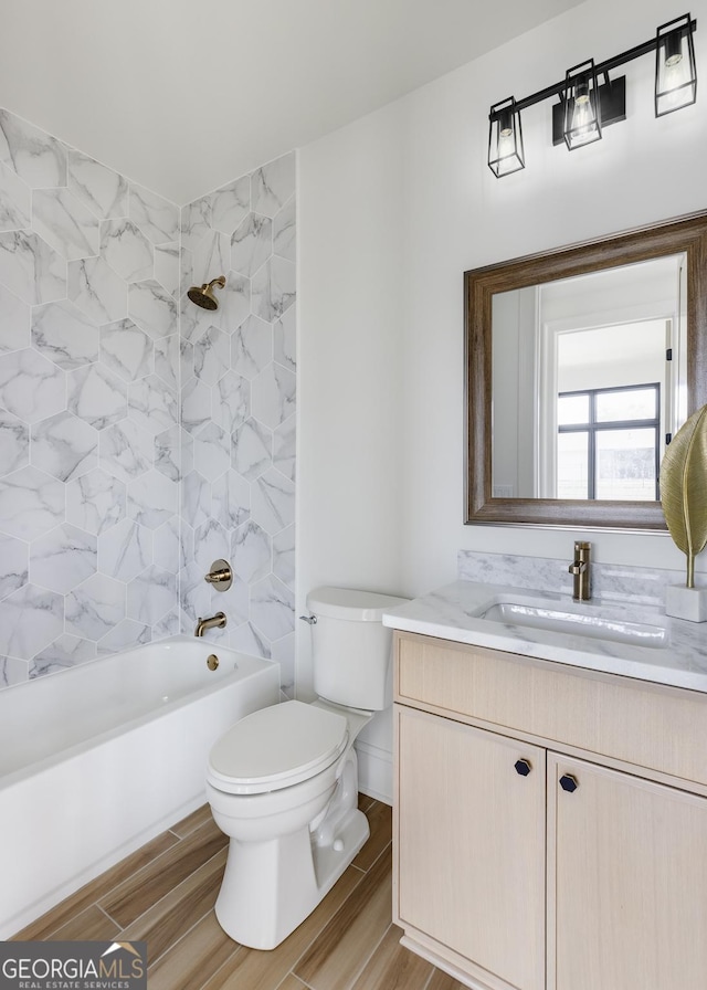 1962 8th St, Chamblee, GA 30341 - full bathroom featuring vanity, toilet, shower / tub combination, and wood finished floors