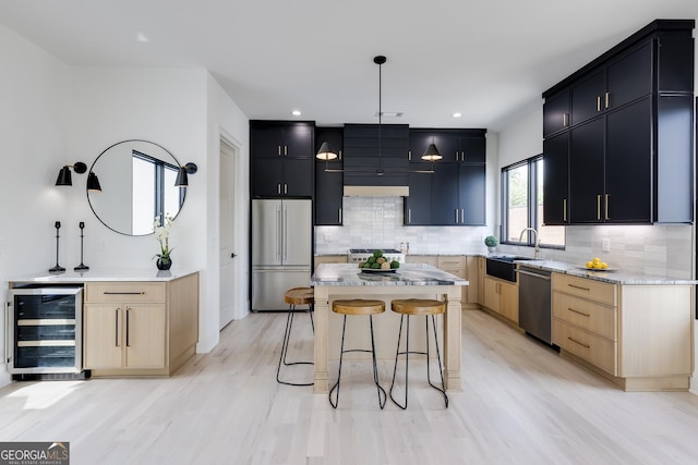 1962 8th St, Chamblee, GA 30341 - kitchen with stainless steel appliances, beverage cooler, a kitchen bar, dark cabinetry, and decorative backsplash