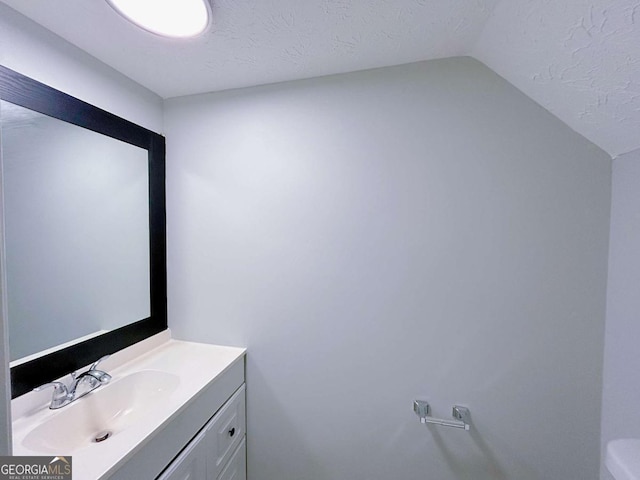 1820 Neely Ave, Atlanta, GA 30344 - bathroom with lofted ceiling, vanity, and toilet