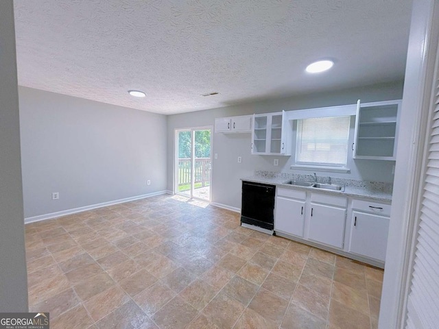 1820 Neely Ave, Atlanta, GA 30344 - kitchen with black dishwasher, a sink, light countertops, baseboards, and white cabinets
