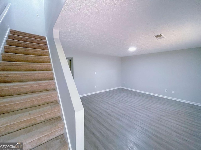 1820 Neely Ave, Atlanta, GA 30344 - stairway with a textured ceiling, wood finished floors, and baseboards