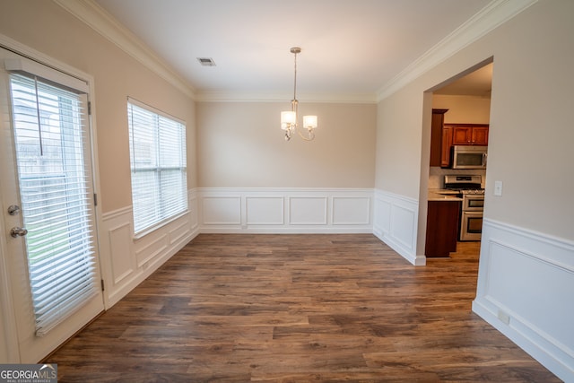 4135 Arch Pass, Cumming, GA 30040 - unfurnished dining area featuring a chandelier, ornamental molding, wainscoting, dark wood-style floors, and a decorative wall