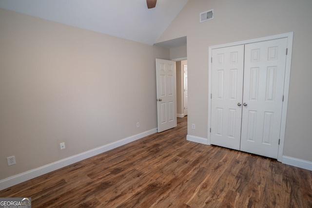 4135 Arch Pass, Cumming, GA 30040 - unfurnished bedroom featuring dark wood-type flooring, high vaulted ceiling, a closet, and a ceiling fan