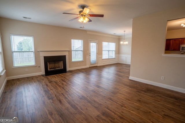 4135 Arch Pass, Cumming, GA 30040 - unfurnished living room with a fireplace with flush hearth, a chandelier, a ceiling fan, dark wood-type flooring, and crown molding