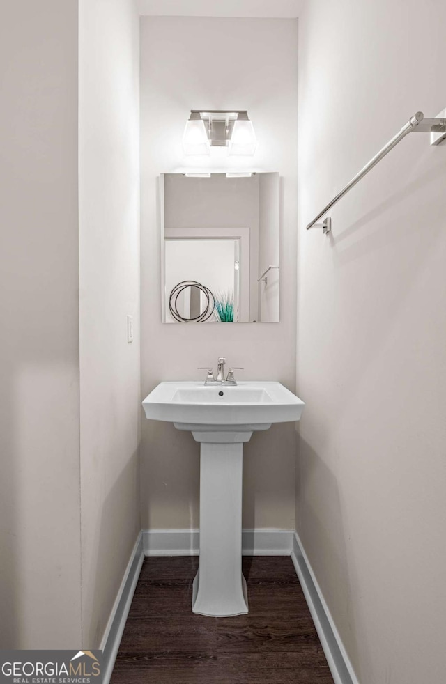 1049 Climbing Rose Way, Mcdonough, GA 30253 - bathroom featuring wood finished floors, baseboards, and a sink