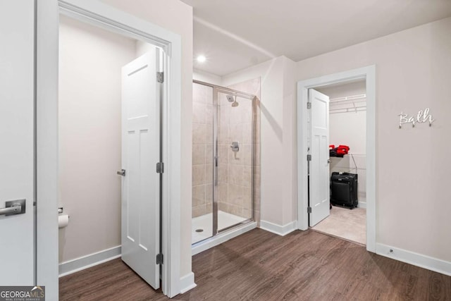 1049 Climbing Rose Way, Mcdonough, GA 30253 - bathroom with a stall shower, wood finished floors, baseboards, a walk in closet, and recessed lighting