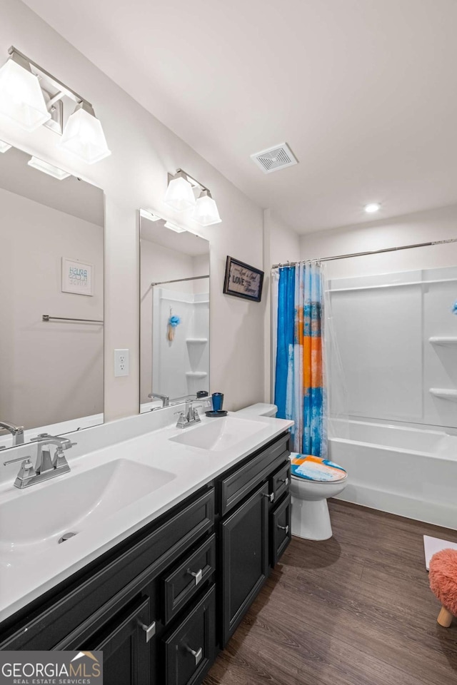 1049 Climbing Rose Way, Mcdonough, GA 30253 - bathroom with double vanity, wood finished floors, shower / tub combo, and recessed lighting