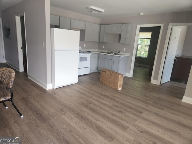 106 Ronald Pride Blvd, Fort Valley, GA 31030 - kitchen with white appliances, gray cabinets, light countertops, and wood finished floors