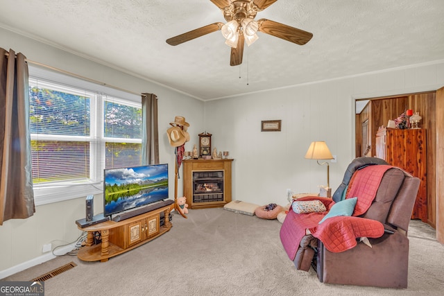 3131 Langley Rd, Loganville, GA 30052 - living area featuring carpet, a lit fireplace, a textured ceiling, a ceiling fan, and crown molding