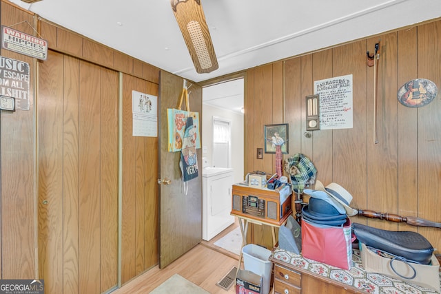 3131 Langley Rd, Loganville, GA 30052 - corridor with washer / dryer, wooden walls, and light wood-style floors