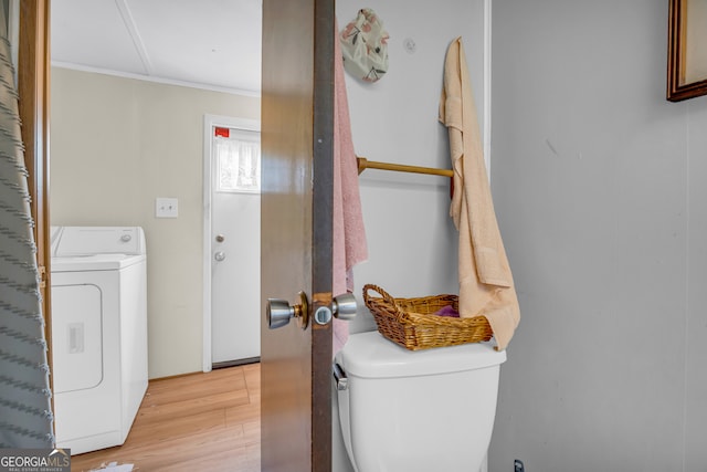 3131 Langley Rd, Loganville, GA 30052 - washroom with washer / dryer, light wood finished floors, and ornamental molding