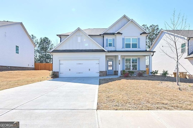 3557 Bryant Meadows Cir, Buford, GA 30519 - view of front of home featuring board and batten siding, driveway, an attached garage, and covered porch