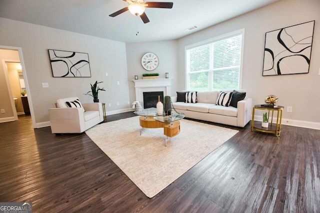 3557 Bryant Meadows Cir, Buford, GA 30519 - living room with ceiling fan, dark wood-type flooring, a glass covered fireplace, and baseboards