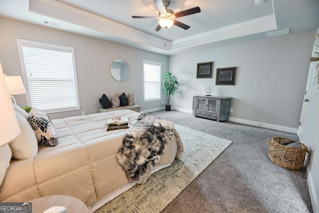 3557 Bryant Meadows Cir, Buford, GA 30519 - carpeted living area with a tray ceiling, a ceiling fan, and baseboards