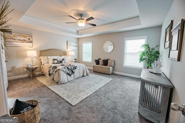 3557 Bryant Meadows Cir, Buford, GA 30519 - carpeted bedroom with a raised ceiling, multiple windows, baseboards, and a ceiling fan
