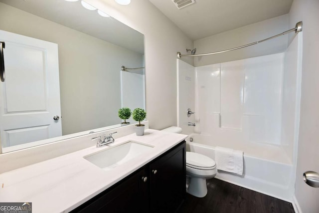 3557 Bryant Meadows Cir, Buford, GA 30519 - bathroom featuring toilet, vanity, wood finished floors, and shower / washtub combination