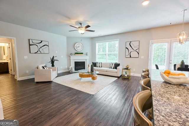 3557 Bryant Meadows Cir, Buford, GA 30519 - living room with dark wood finished floors, ceiling fan, a glass covered fireplace, and baseboards