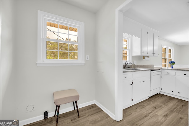 234 Edgewood Dr, Mount Airy, GA 30563 - kitchen featuring white dishwasher, a sink, light wood-type flooring, and light countertops