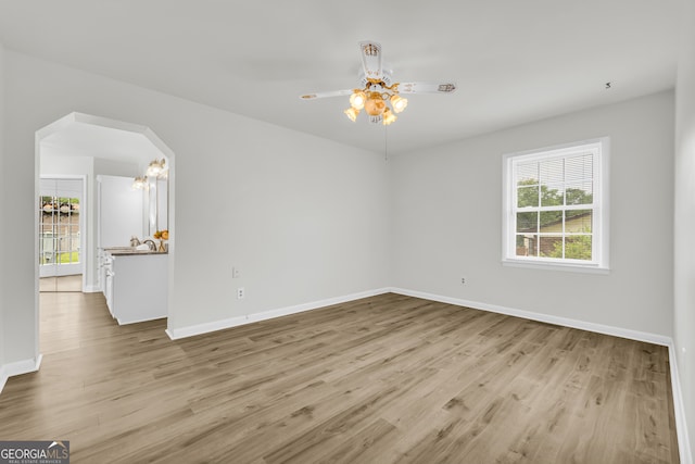 234 Edgewood Dr, Mount Airy, GA 30563 - spare room with wood finished floors, arched walkways, and baseboards