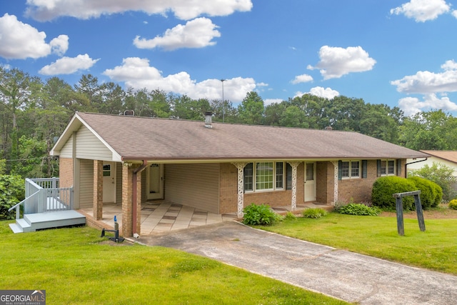 234 Edgewood Dr, Mount Airy, GA 30563 - single story home with asphalt driveway, brick siding, an attached carport, a front yard, and roof with shingles