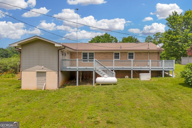 234 Edgewood Dr, Mount Airy, GA 30563 - back of property featuring a wooden deck, a lawn, and brick siding