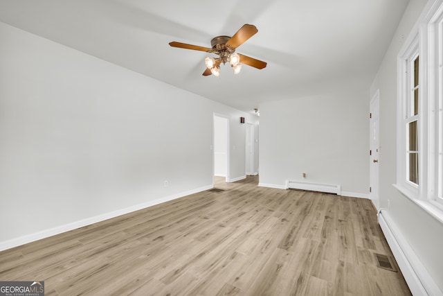 234 Edgewood Dr, Mount Airy, GA 30563 - empty room with a baseboard radiator, a ceiling fan, light wood finished floors, and baseboards
