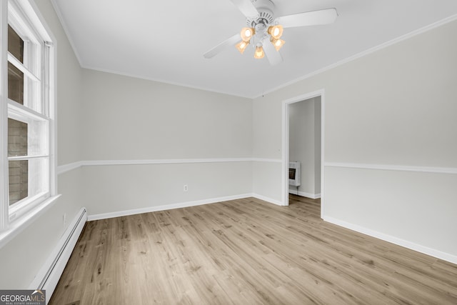 234 Edgewood Dr, Mount Airy, GA 30563 - empty room with a baseboard heating unit, ceiling fan, heating unit, wood finished floors, and crown molding