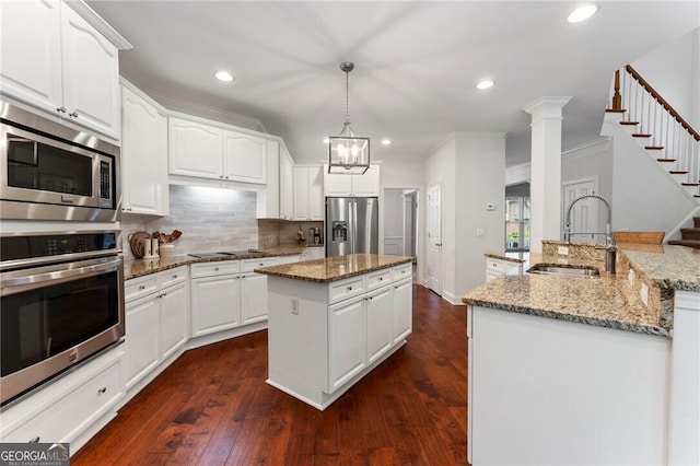 1055 Beacon Hill Xing, Alpharetta, GA 30005 - kitchen with stainless steel appliances, a sink, a kitchen island with sink, tasteful backsplash, and recessed lighting